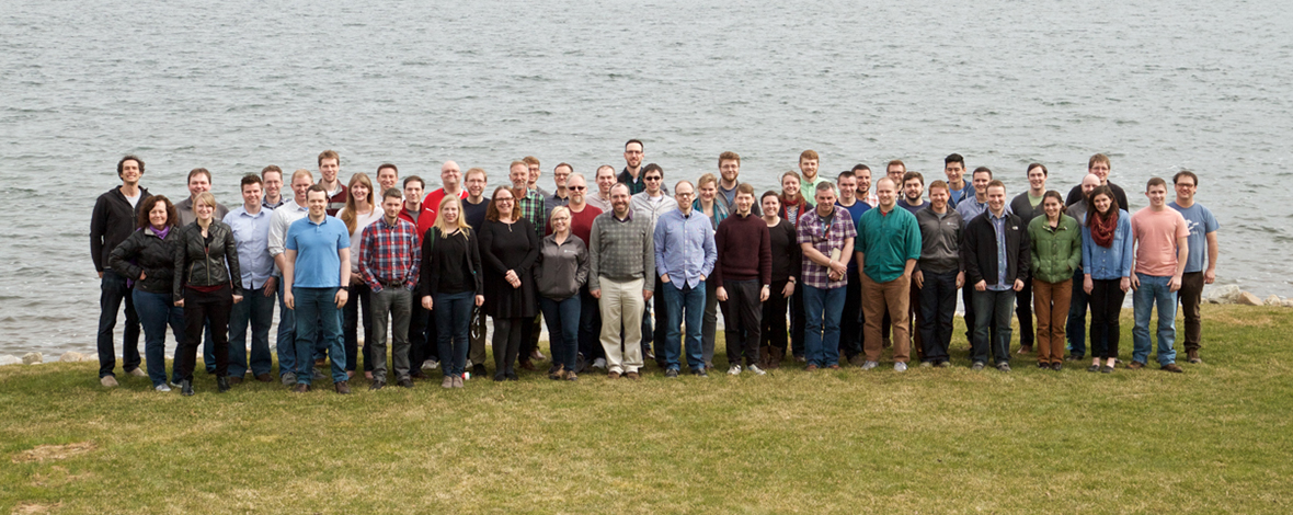 A photo of all Atomic Object employees standing by a lake.
