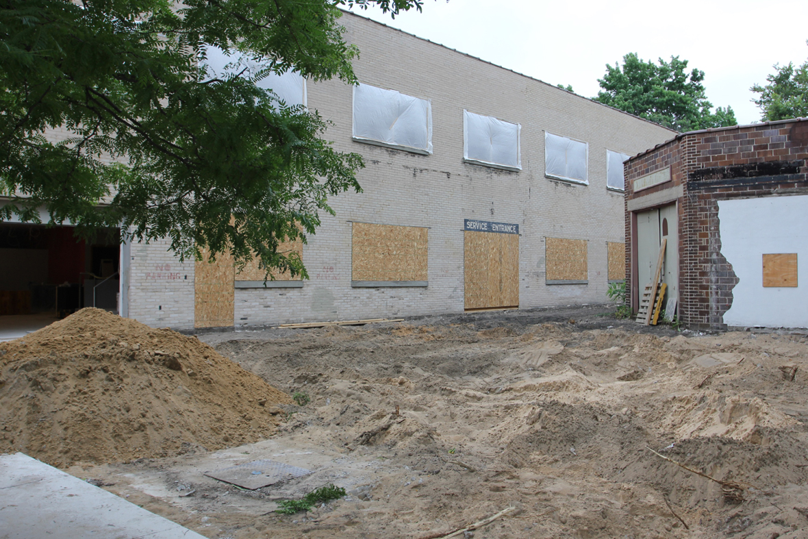 Exterior of the two buildings with the grass torn out.