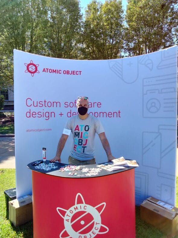 Dylan standing at the AO recruiting booth outside, wearing a facemask