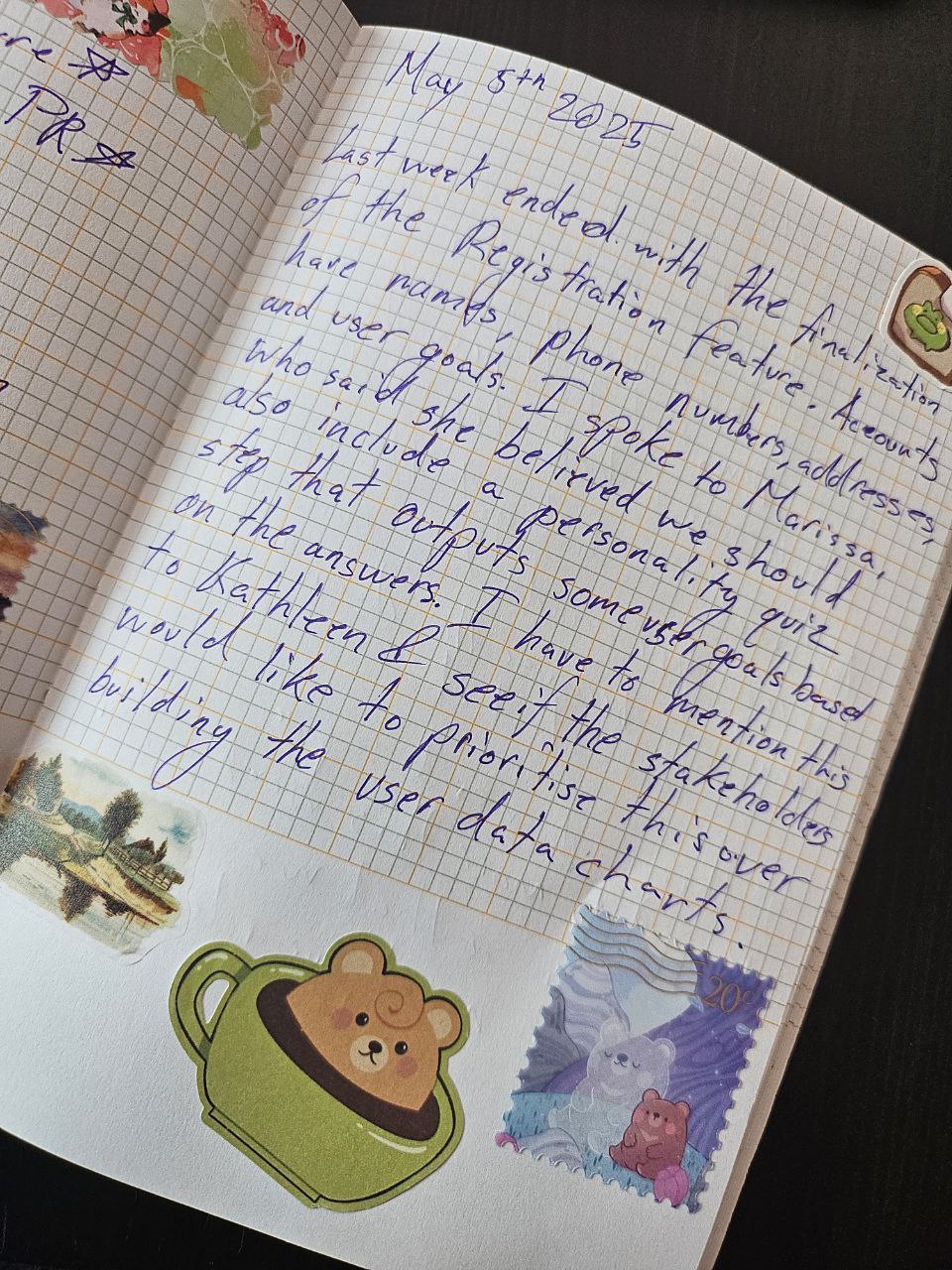 Journal Entry dated May 5th 2025. There are stickers on the page. The entry reads: Last week ended with the finalization of the Registration feature. Accounts have names, phone numbers, addresses, and user goals. I spoke to Marissa who said she believed we should also include a personality quiz step that outputs some user goals based on the answers. I have to mention this to Kathleen & see if the stakeholders would like to prioritise this over building the user data charts.
