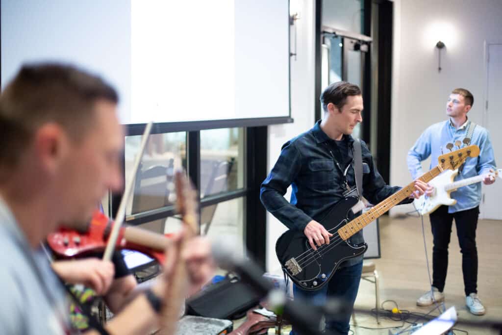 Several Atomic members playing rock and roll, illustrating the post titled Play More: Creating Community with Your Existing Office Network