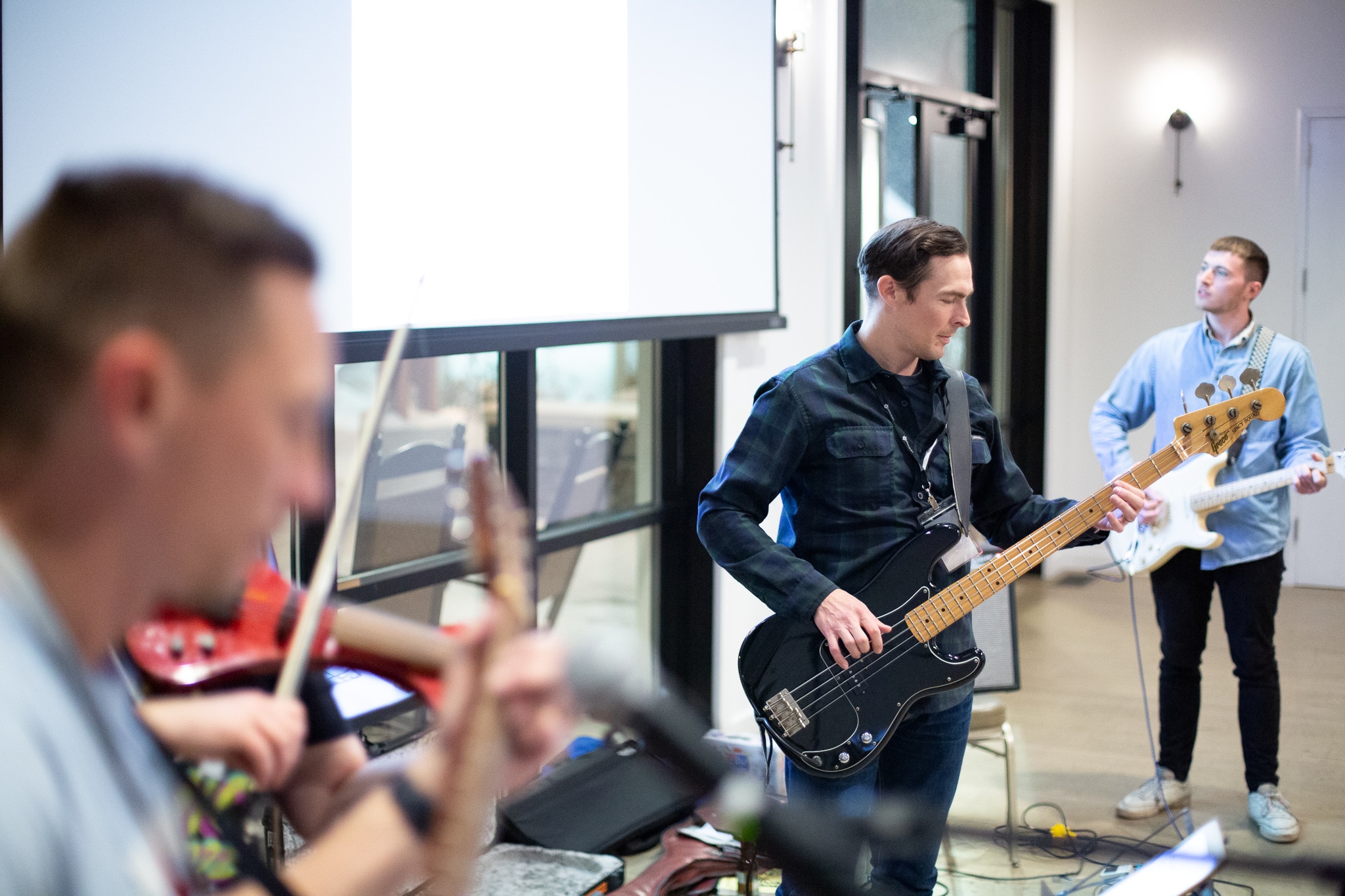 Several Atomic members playing rock and roll, illustrating the post titled Play More: Creating Community with Your Existing Office Network