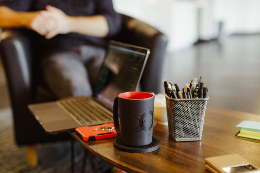A coffee mug bearing the Atomic Object logo. Post title: Build an Environment that Allows Mistakes