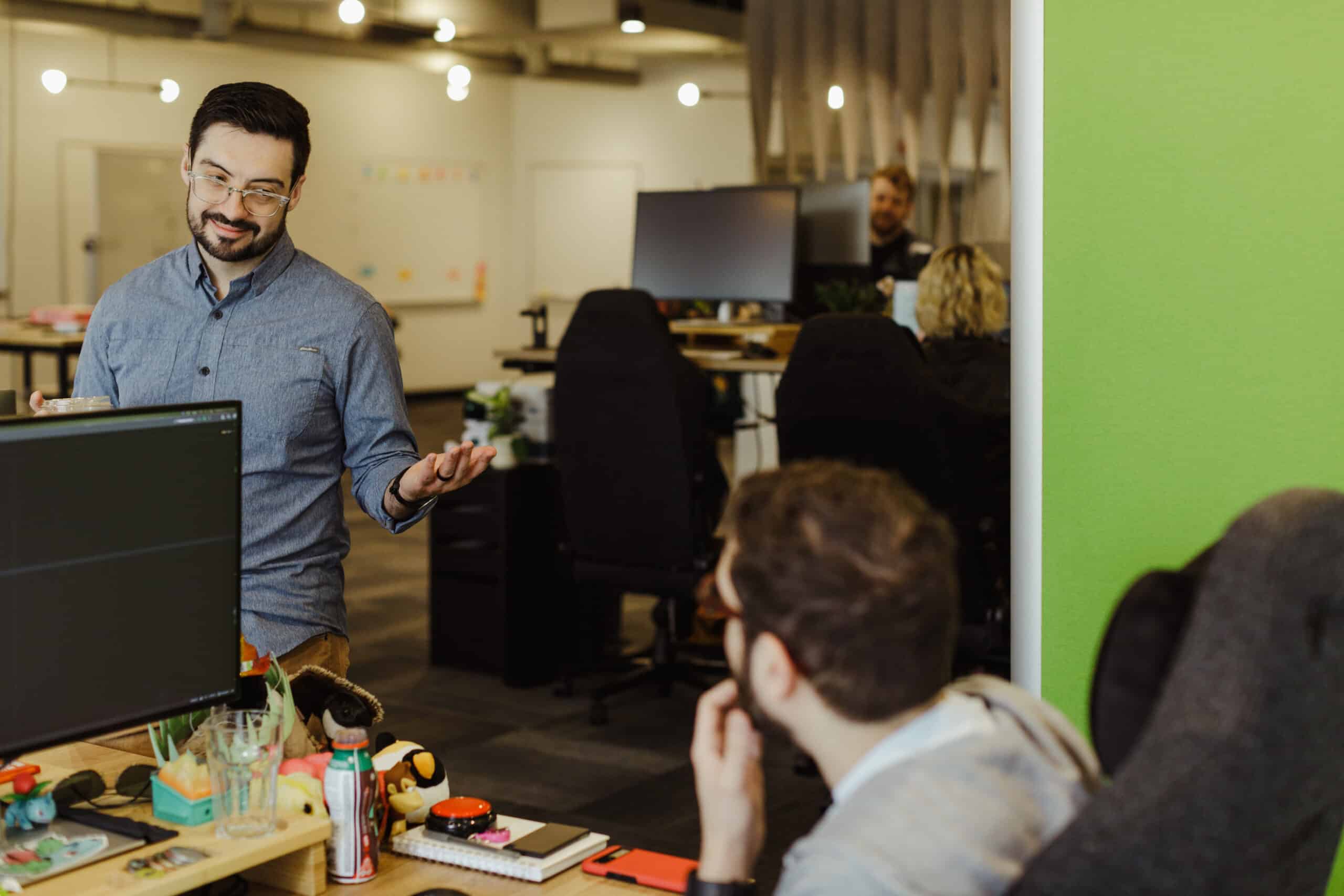 Author Sam Laidlaw chats with a co-worker. Post title: Know Your Audience and Cut the Noise: Executive Storytelling That Actually Works