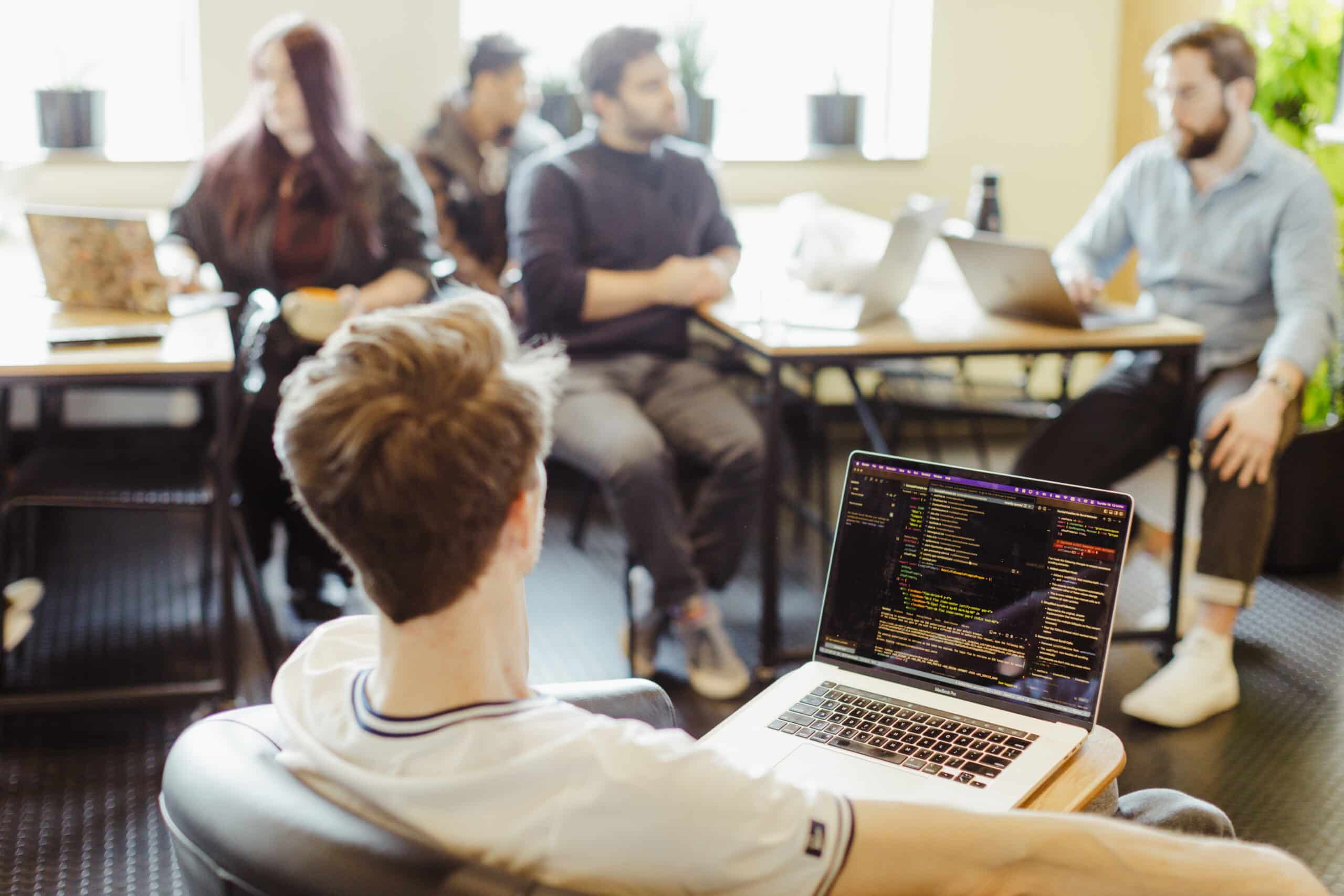 Pictured are a team of developers talking to one another. Post title: Learn to Use Rapid Prototyping Sprints in Cursor