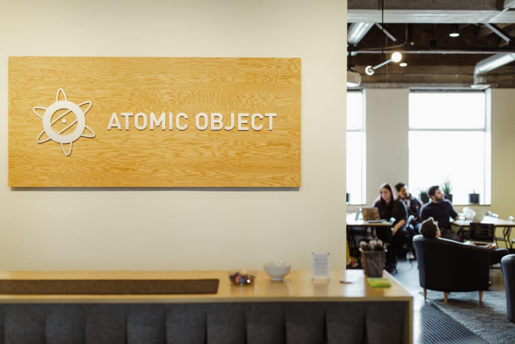 The interior of Atomic Object's Ann Arbor office. Post title: Your Legacy Code Isn't the Problem