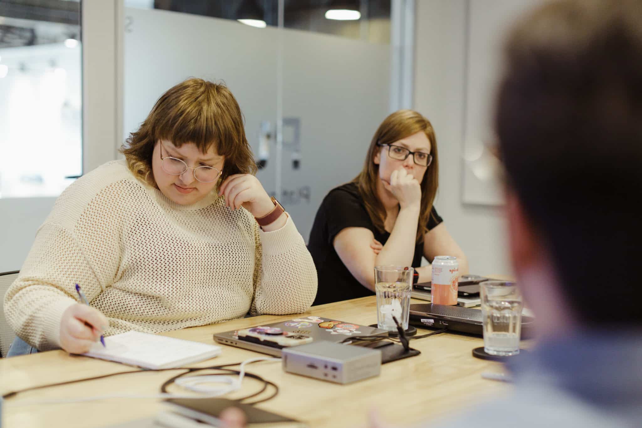 Pictured is the author taking hand-written notes. Post title: Stop Trying to Make Your AI Writing Sound Human