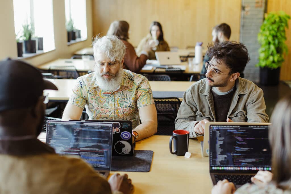 Author Dylan Goings with co-workers. Post title: AI and the Shifting Boundary of Software Development