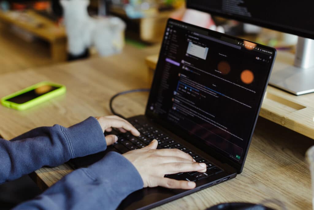 Developer's hands on a keyboard. Post title: Test GitHub Actions Locally with Act
