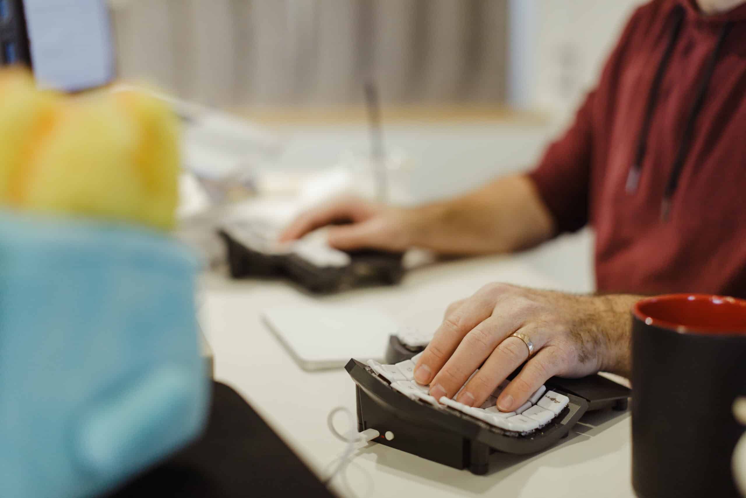 Pictured is an arm and a hand on a computer mouse. This illustrates the article "Don't Let Technical Debt Ruin You"