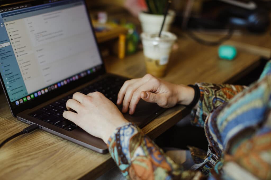 A developer's hands on a keyboard. Post title: Will AI-written Software Fit Like A Glove?