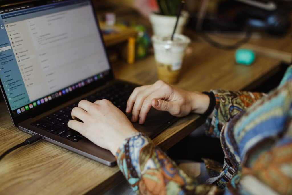 Pictured are hands on a laptop keyboard. Post title: Memgraph Query Optimization - Tips and Helpful Hints