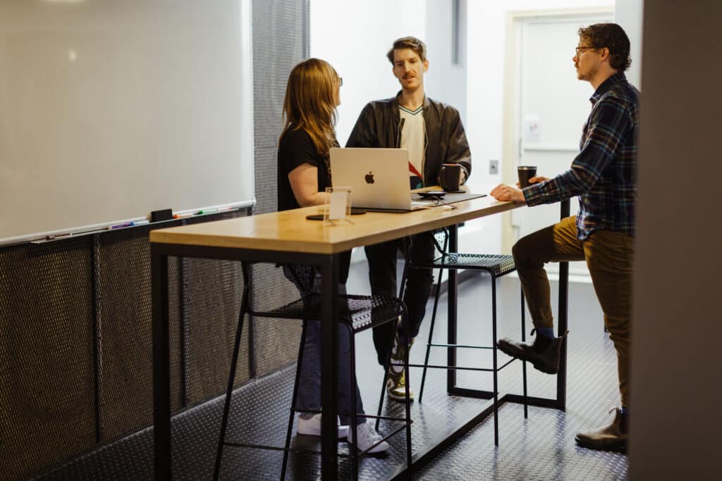 Pictured are developers at Atomic Object's Ann Arbor office. Post title: I’m An AI Skeptic—Here’s How I Use AI