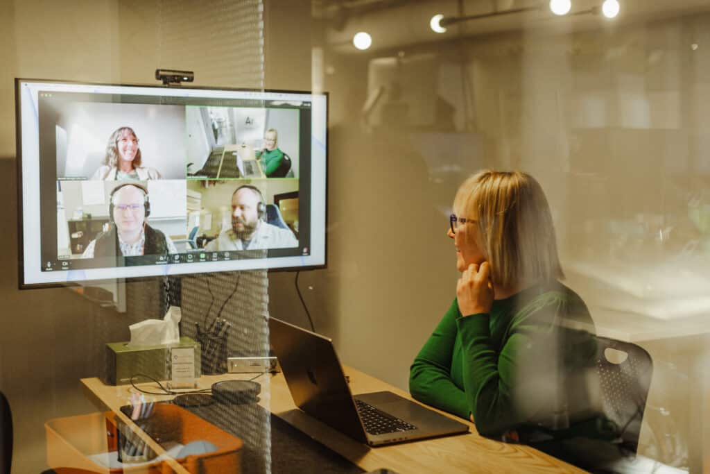 Pictured are Atomic Object Ann Arbor employees on a remote video call. Post title: Making Remote Work Human: Building Culture from a Distance