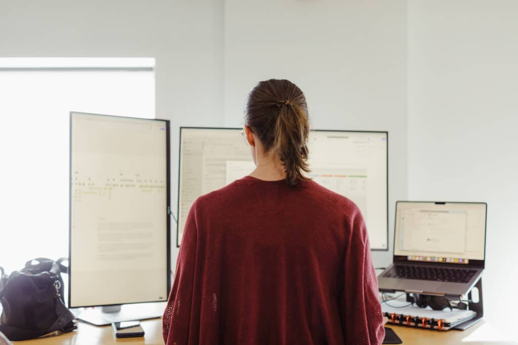 A developer in front of her monitor. Post title: Don't Stick a Laser In Your Face (A Parable): Power Tools & Ignorance
