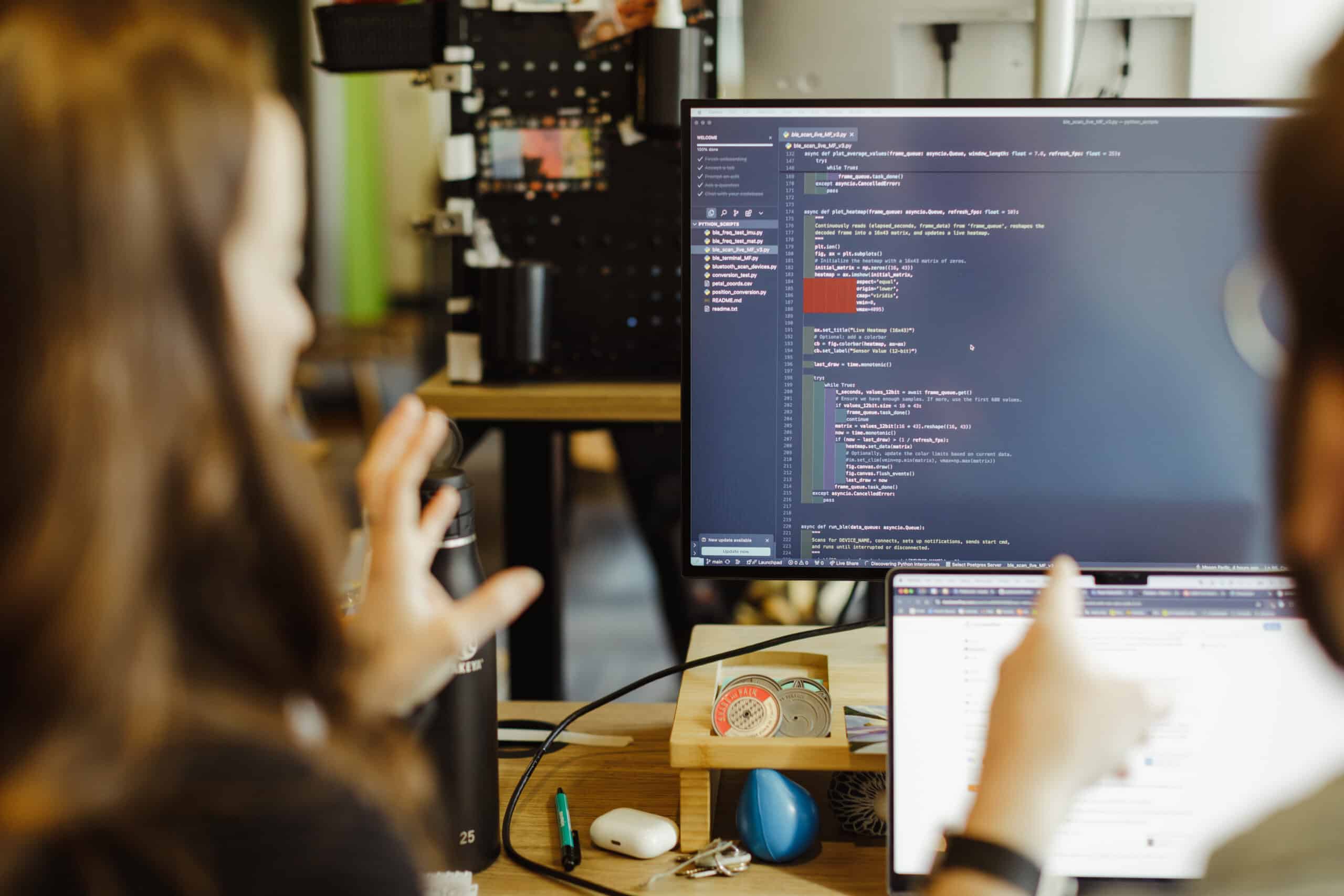 Pictured is author Elaine Ezekiel gesturing at a monitor. Post title: How to Kindle an AI-Curious Culture in Your Team