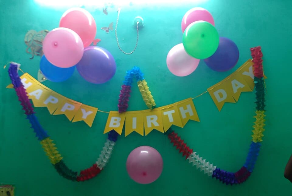 Decorations spelling out "Happy Birthday." Post title: Never Missing a Birthday Again with Sheets + Slack