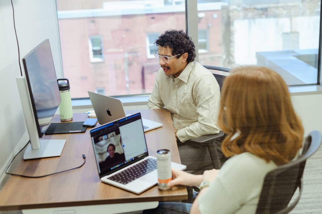 Pictured is author Jordan Booker with a workmate. Post title: How JSDoc Saved My Dev Workflow