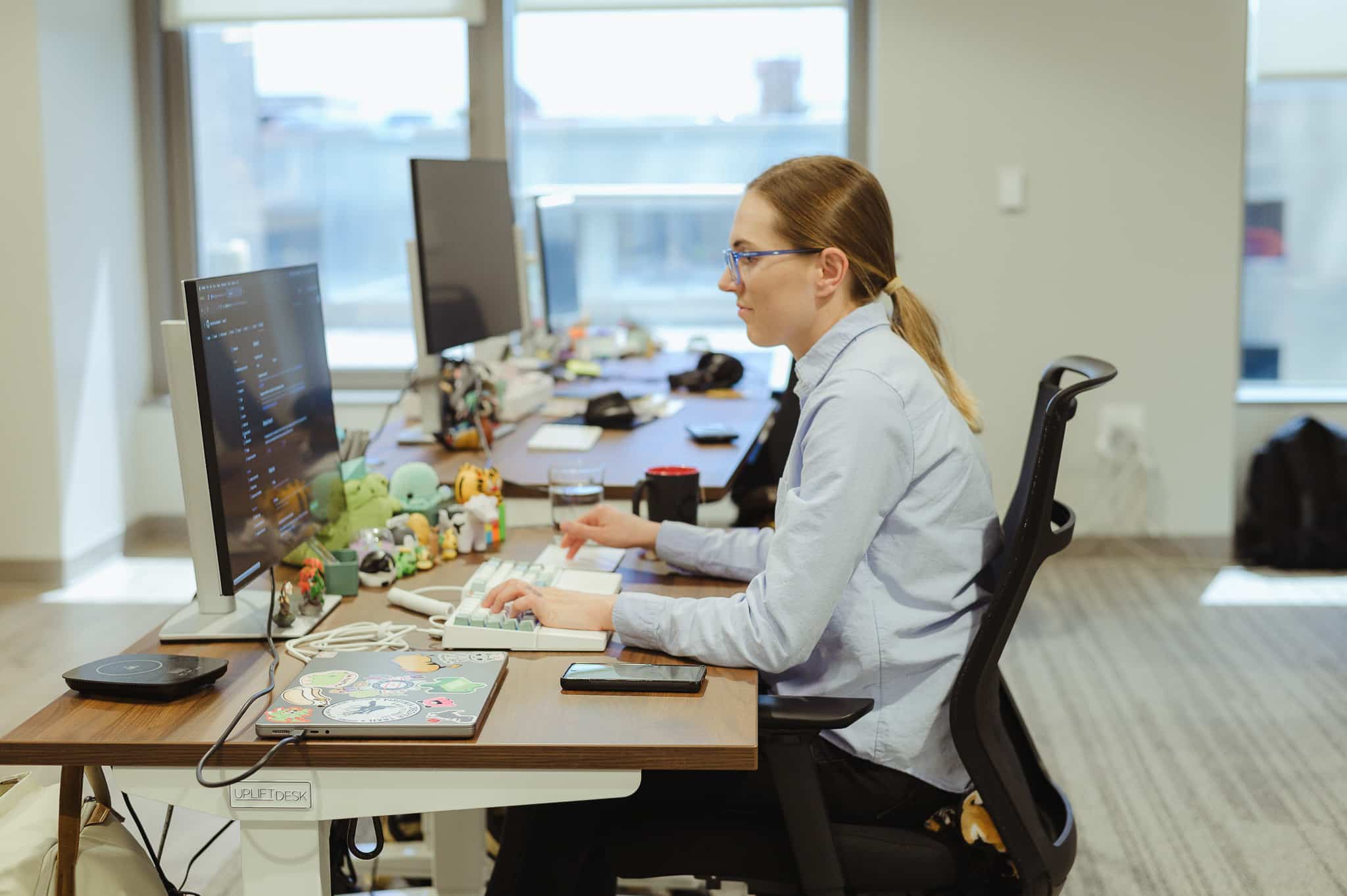 Pictured is author Danielle Wisen at her desk. Post title: 3 TypeScript Tips You Should Know About