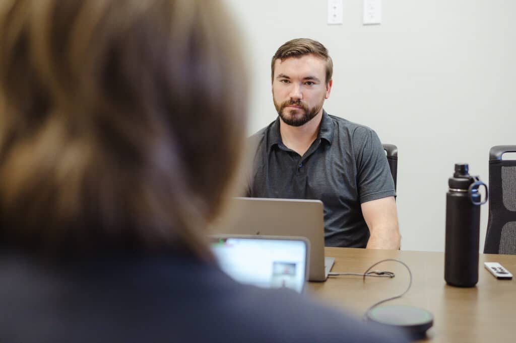 Pictured is author Ryan Abel, discussing first principles in custom software.