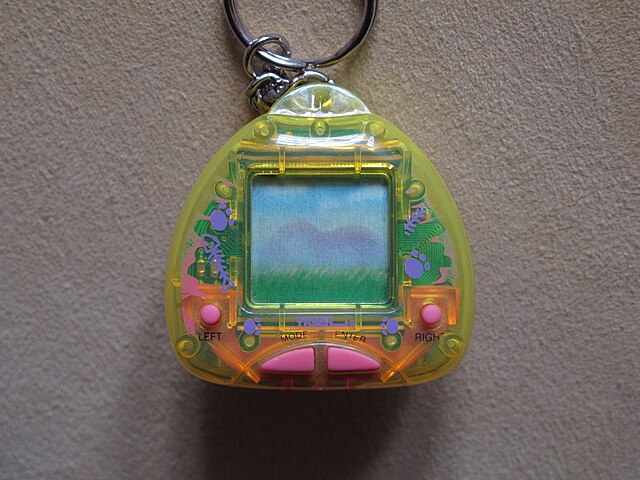Pictured is a Giga Pet device. Post title: How I Built a Virtual Pet App in Flutter