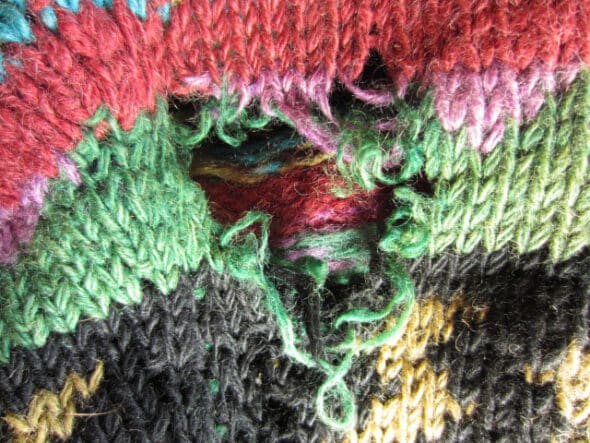 A piece of knitting with a large hole.