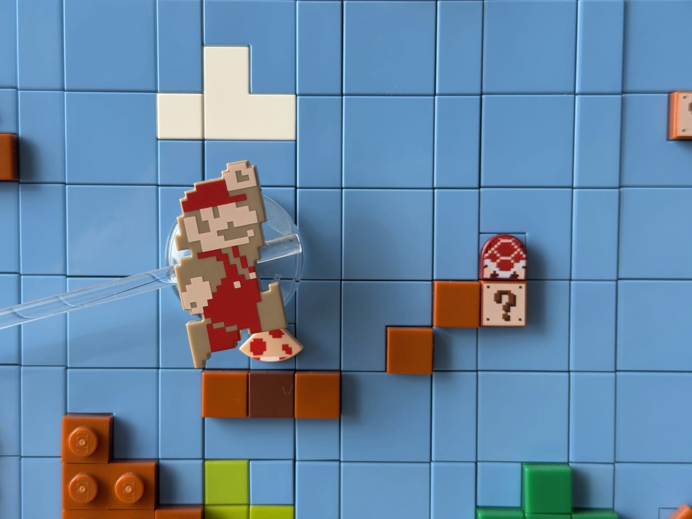 Mario mounted on a clear pole and resting on a platform. As the scene scrolls, Mario will climb platforms and drop down.