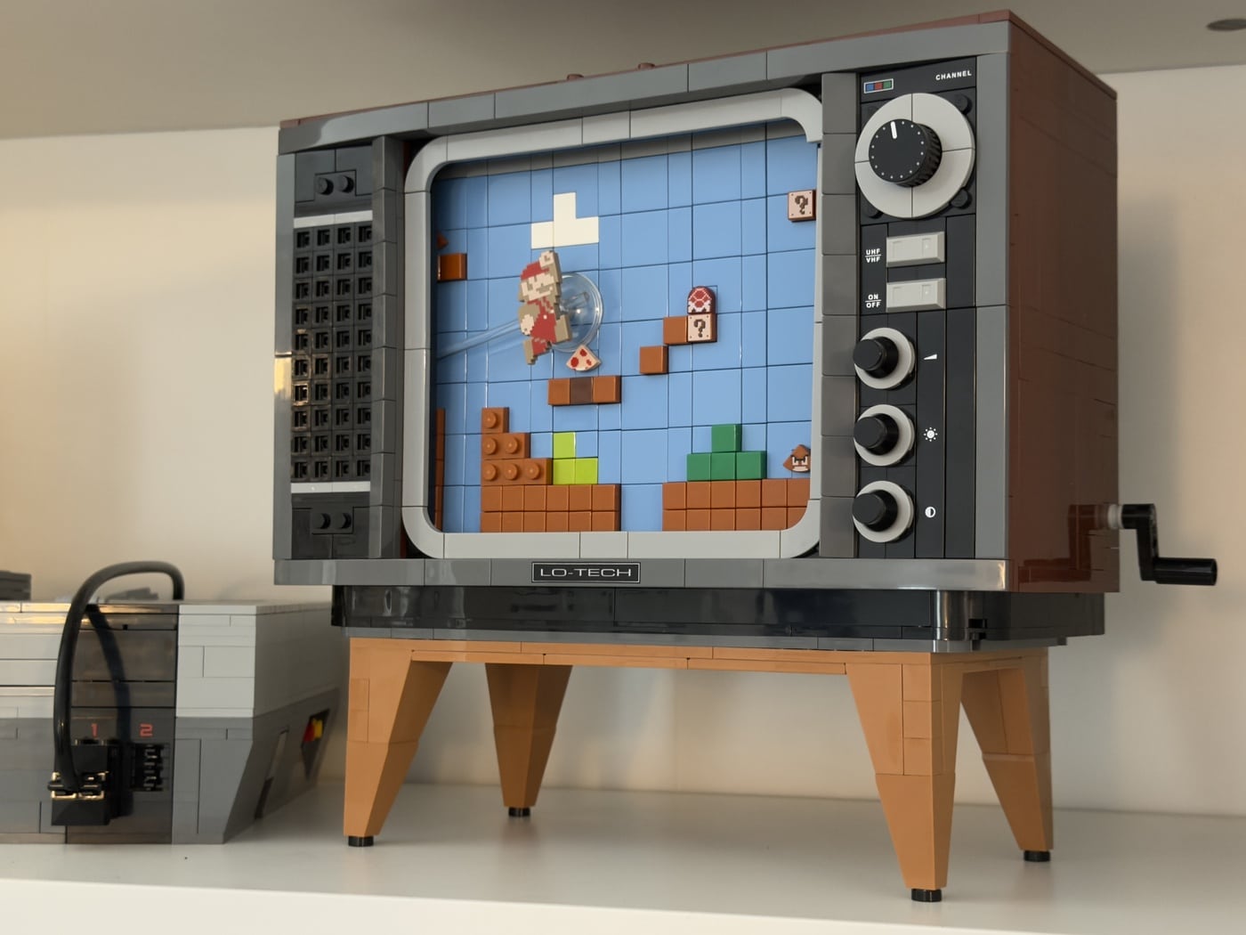 The finished NES TV, showing the Super Mario Bros. scene. A crank is mounted on the right side by which the scene can be operated.