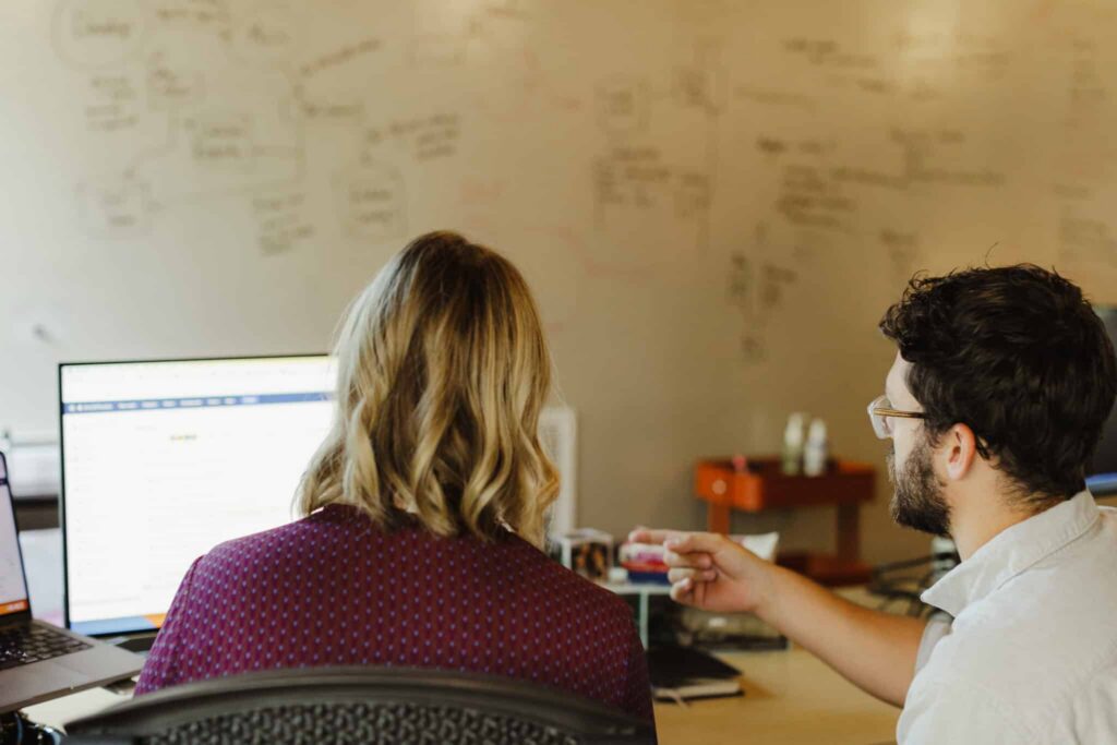Author Meg Kretz with a colleague. Post title: How AI Let a Non-Technical Delivery Lead Work in the Data Layer