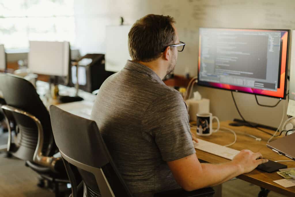 A developer in front of his computer. Post title: Your Hobbies Should Inspire Your Growth as a Developer
