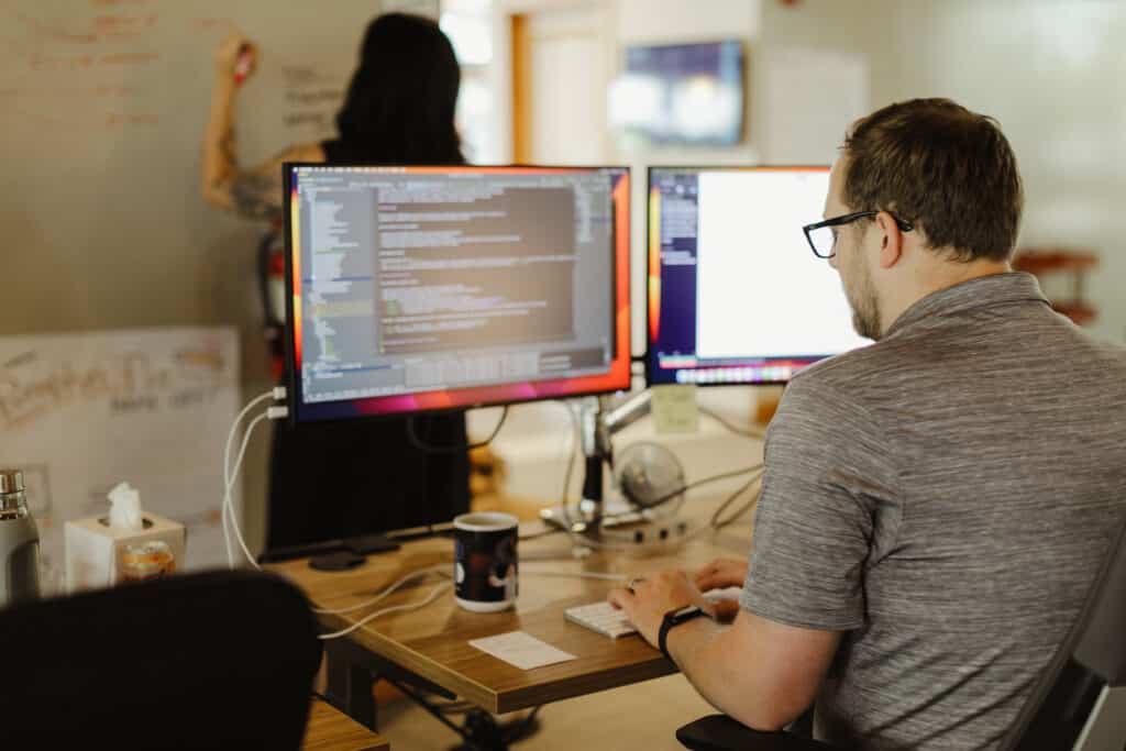 A developer looking at his monitor. Post title: Write End-to-End Tests in Your Backend's Language