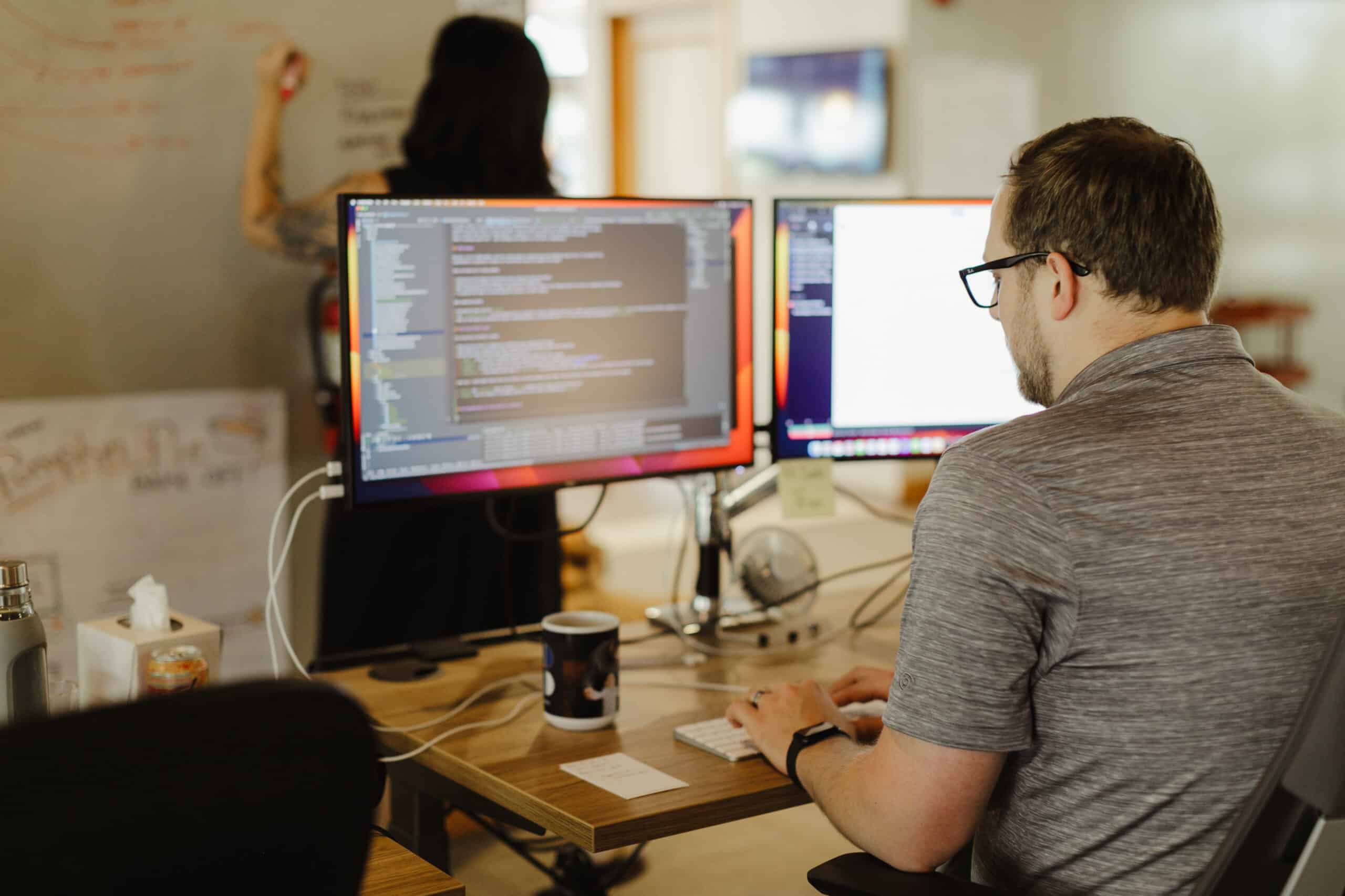 A developer looking at his monitor. Post title: Write End-to-End Tests in Your Backend's Language