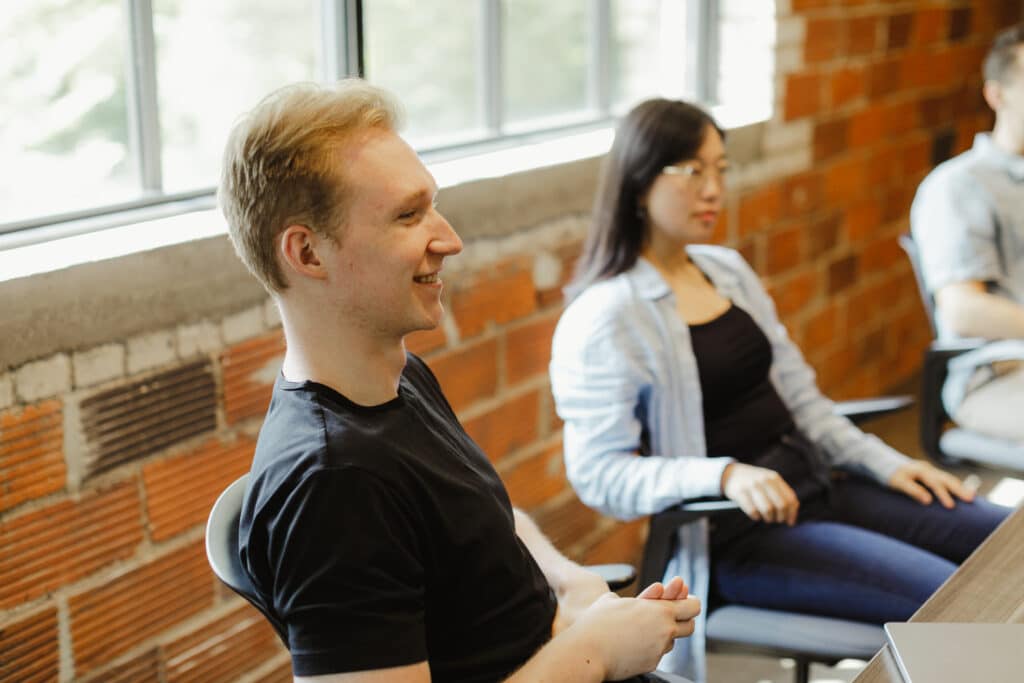 Pictured is author Matthew Harper and other developers discussing the topic: Why Developer Experience Matters in Software Consulting