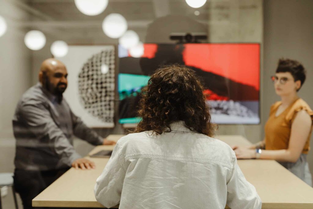 A team of developers. Post title: Look Beyond Velocity: Will This Sprint Unblock the Next One?