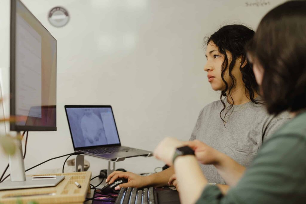 Two developers look at a monitor. Post title: How to Optimize Your Agentic-Developed Android Developer Workflow