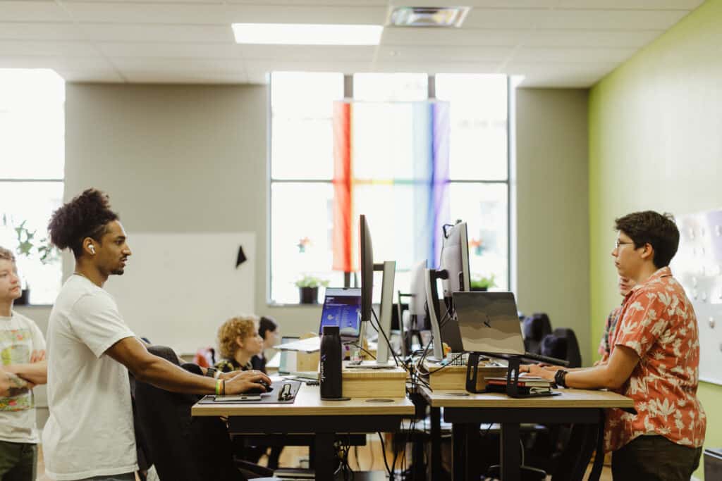 Pictured is author Casey Falkowski with co-workers. Post title: Bringing Confidence to Complex Data Migrations with Snapshot Testing