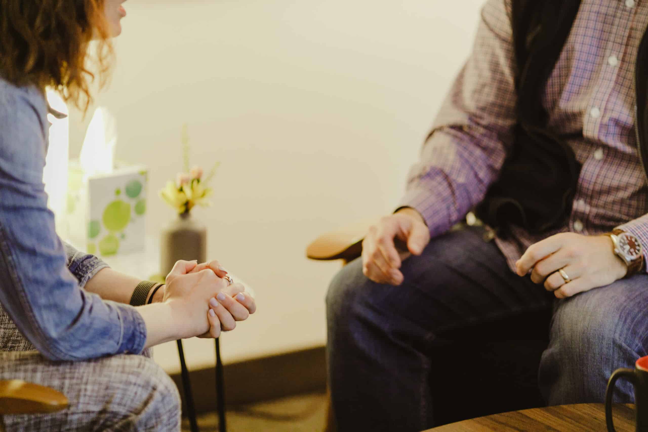 Two people in a tense conversation. Post title: How Ineffective Communication Can Be the Real Delivery Bottleneck