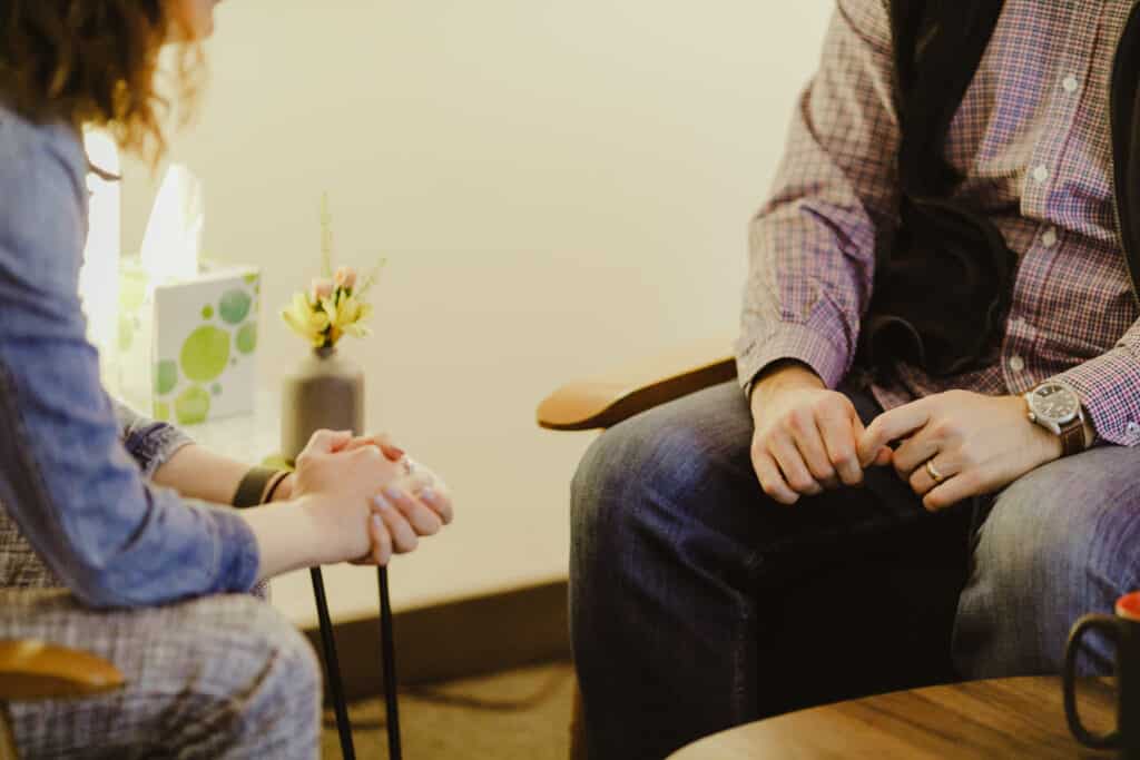 Shown are two people having an intense conversation. Post title: Mindfulness: A Tool That Can Prevent Deadlocks and Defensiveness