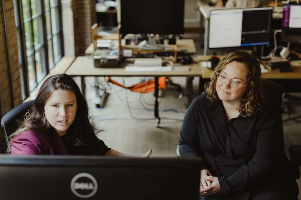 Pictured is post author Kim Crawford talking to a coworker. Blog post title: Tell the Best Tale with the Nugget + SAR Method