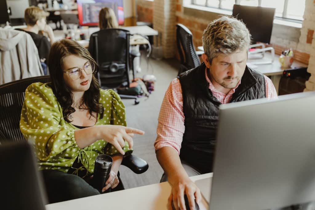 Pictured at right is author Kyle Harris talking to a co-worker. Post title: Vibe Coding is Fun, but Building Meaningful Software Still Takes a Real Team