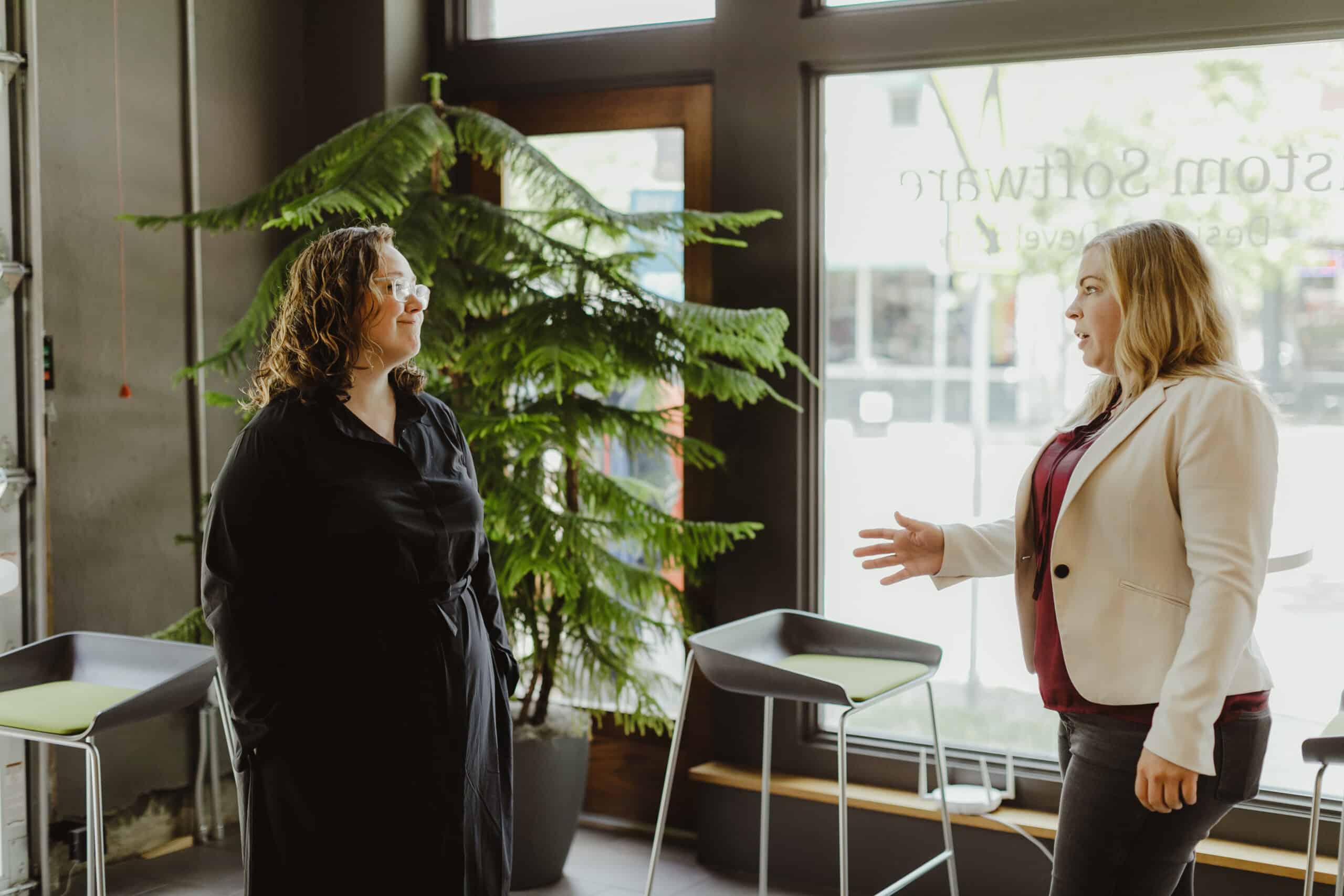 Pictured are two Atomic Object employees dicussing 2025 Tech Trends and What They Mean for Your Business