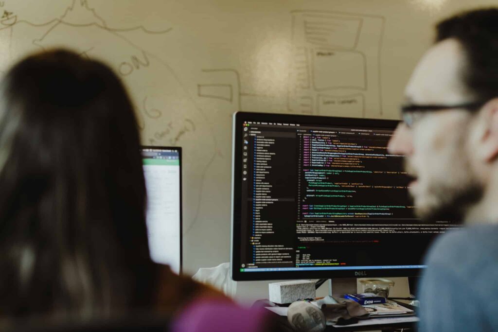 Author Patrick Bacon with a colleague. Post title: Understanding iptables with WireGuard