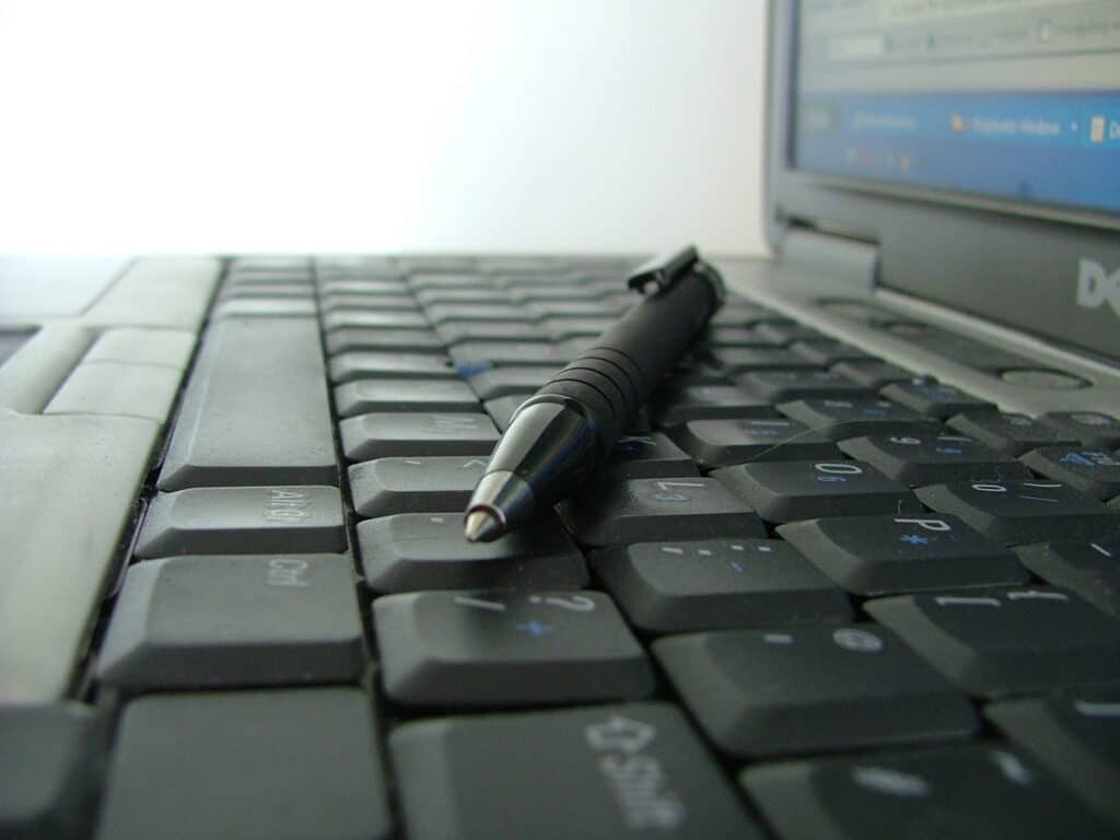 Shown is a keyboard with a pen resting on it. Post title: Review: Codex Tools for Improving Accessibility