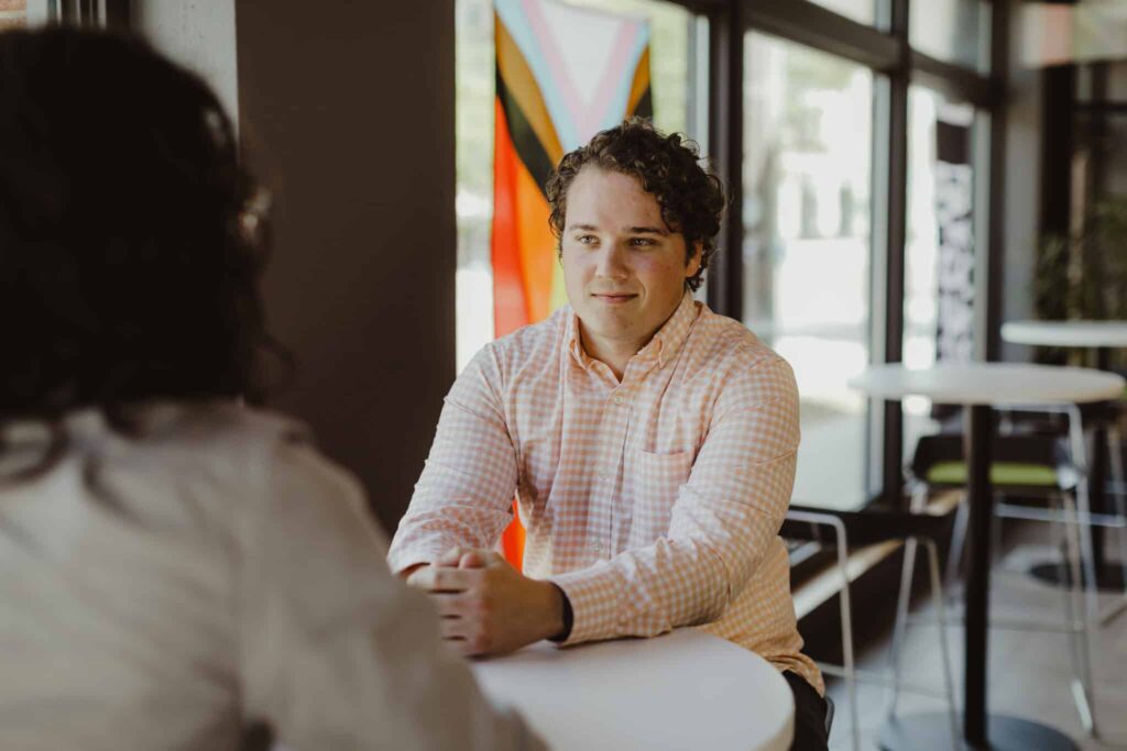 Author Louie Berwanger talks to a co-worker. Post title: Test DynamoDB with Jest Shelf