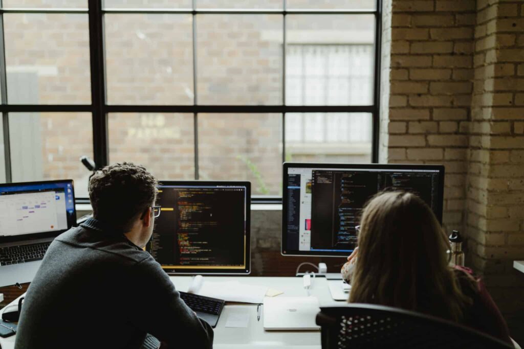 Author John Ruble with a colleague. Post title: How to Run SQL Server Outside Docker Sandboxes
