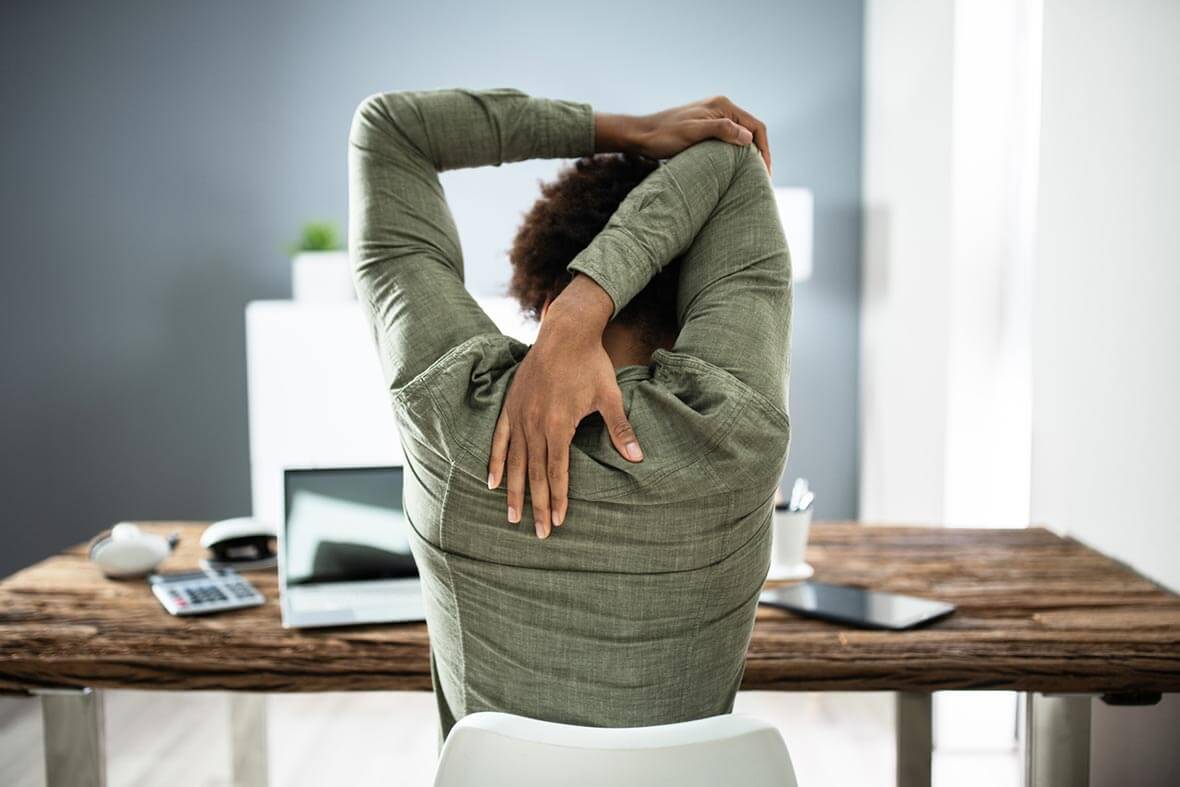 Person stretching at their desk