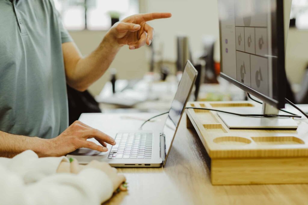 A hand points at a monitor. Post title: Form Fatigue? Let Cypress and Faker.js Do the Dirty Work