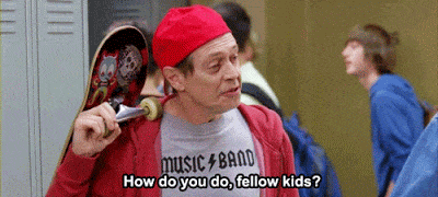 A gif showing a scene from the show 30 Rock where actor Steve Buscemi, dressed in youth clothing and holding a skateboard, says to some children by lockers, "How do you do, fellow kids?"