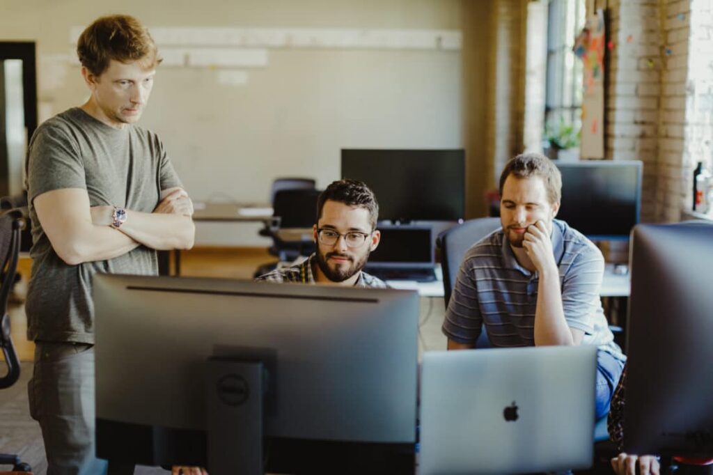 Pictured is author Matt Fletcher with co-workers. Post title: How I Build My Ubuntu 26.04 Cloud-Init Template for Proxmox
