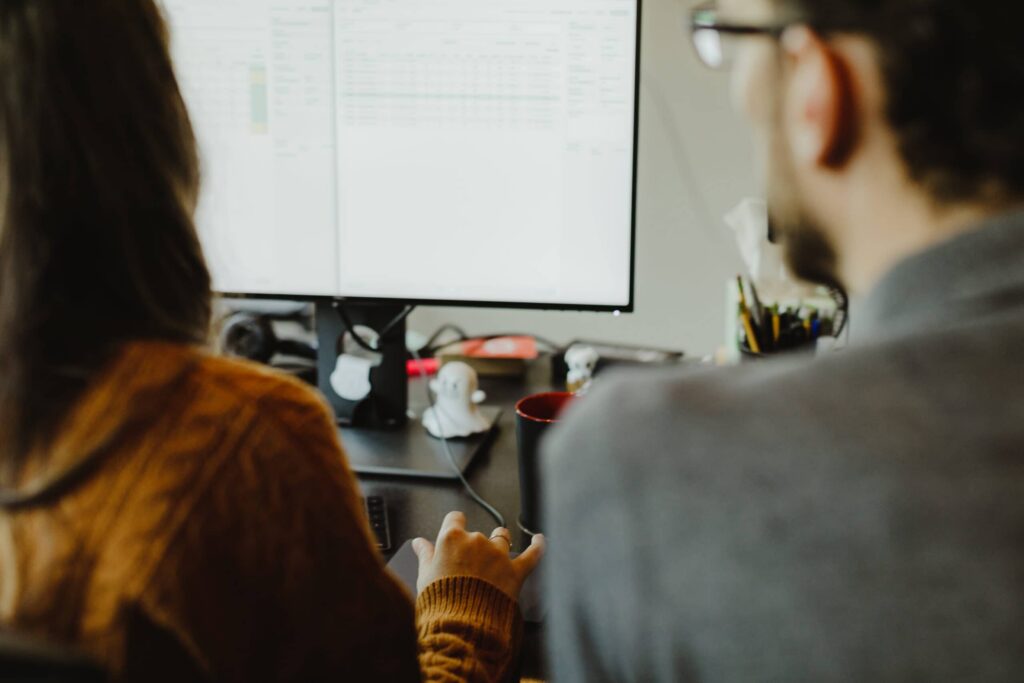 Two developers look at a monitor. Post title: Blocked by Unifi - Troubleshooting a Home Networking Issue